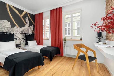 A bright, modernly decorated bedroom space with two separate beds.