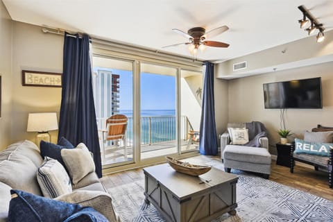 Living room with sleeper sofa and entrance onto the balcony.