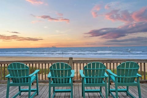 Spacious beachfront deck with turquoise rocking chairs and panoramic Gulf views, perfect for relaxing mornings and sunset gatherings in Crystal Beach, Texas.