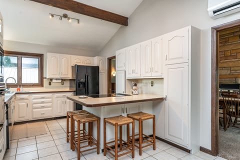 Enjoy meals and conversation around the large center island with seating for four, set in a stylish kitchen with ample storage.