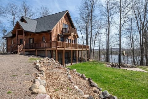 Private hilltop log home surrounded by forest and open acreage