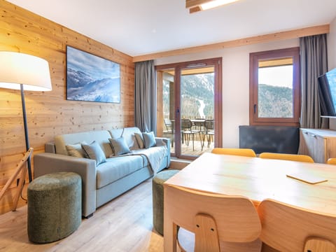 Relax in the cozy living area, where soft cushions invite you to unwind after a day of adventures.