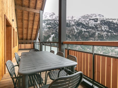 Gather around the spacious outdoor table on your private balcony, perfect for al fresco dining.