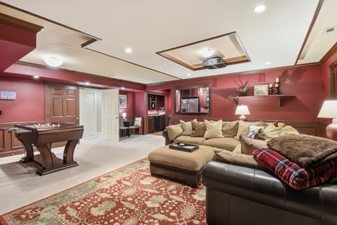 Living/theater room area with 98" project-style TV, surround sound & 500 movies.
