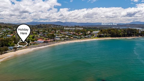 Aerial view showing the property’s prime coastal location near the beach.