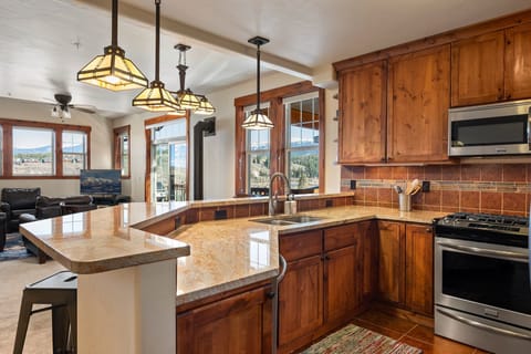 Kitchen With Custom Granite Countertops, Cabinetry, And Lighting