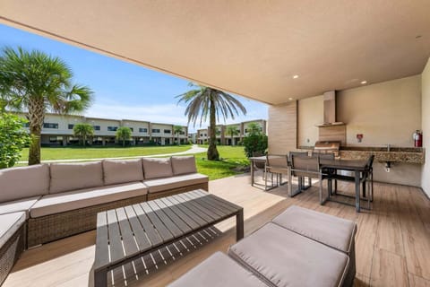 Relax in style with a cozy outdoor living area, with BBQ grill, perfect for family cookouts and evening gatherings under the Florida sky.