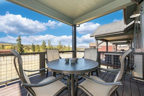 Upper level patio with dining table and BBQ grill