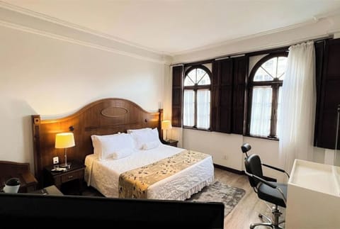 Wake to golden light beside charming arched windows and shutters