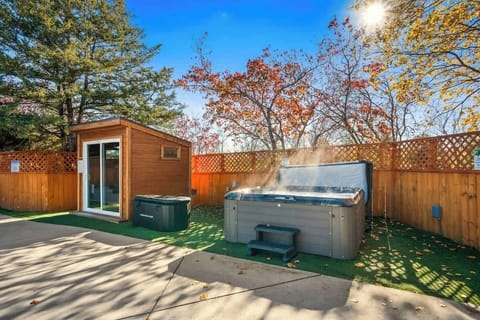 Backyard wellness corner w/ sauna cabin & cold plunge tubs for the ultimate hot-and-cold reset.