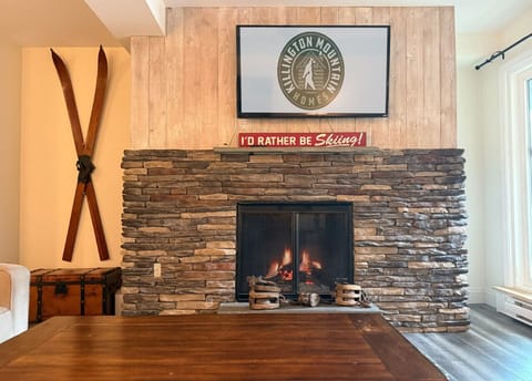 Stay cozy and entertained in our inviting living room with fireplace and big-screen TV.