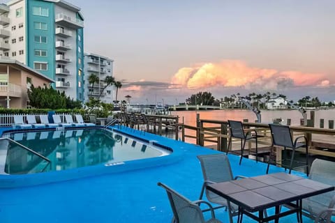 Patio with dining table overlooking peaceful bay waters.
