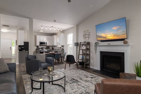 Large living room with multiple seating areas and a smart TV.