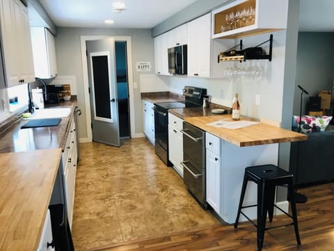 Fully stocked kitchen • Bar Area • Natural light • Farmhouse sink • Plants