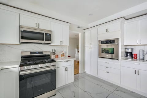 Fully equipped kitchen with stainless steel appliances — perfect for home-cooked meals.