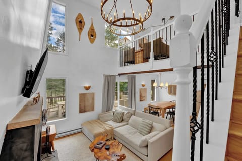 Bright Living Room with Vaulted Ceilings and Loft Overlook