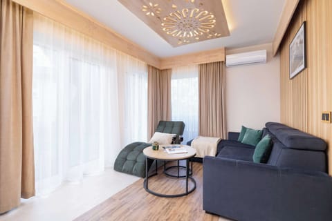 Lounge area with soft sofa, coffee table and chaise longue.