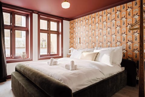 Wake up to soft Bergen light filtering through heritage windows. The warm tones and patterned wallpaper add a touch of nostalgia while ensuring modern comfort for a restful stay