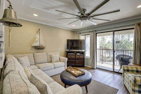 Cozy living room with a sectional sofa and balcony access for natural light.