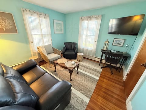 Living room with 48 inch TV, power couch has USB ports. Desk has USB ports.