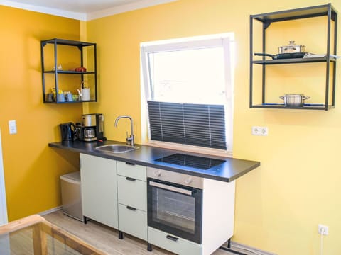 Yellow, Interior Design, Furniture, Kitchen, Kitchen Appliance, Flooring, Cabinetry, Lighting, Countertop, Floor