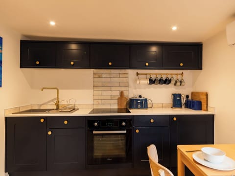 Kitchen, Countertop, Kitchen Appliance, Cabinetry, Interior Design, Major Appliance, Wood, Flooring, Furniture, Lighting