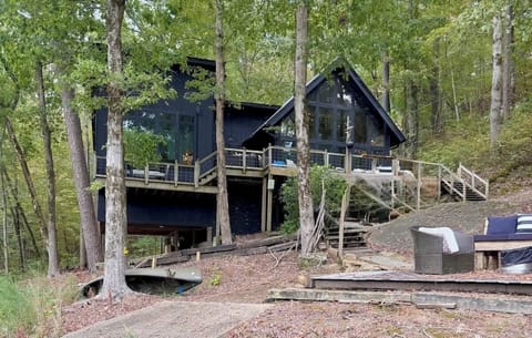 Modern black lake house nestled in the trees—your private Smith Lake retreat begins here.