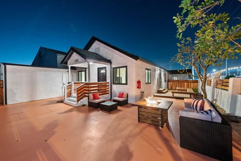 Cozy outdoor space with firepit, stylish seating, and warm lighting.