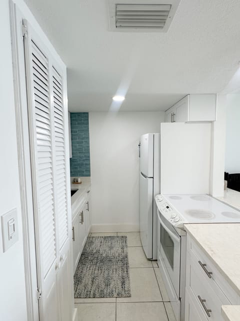 View of Kitchen with oven and refrigerator