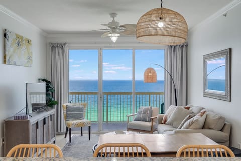 Spacious living room with stunning turquoise Gulf views—relax in coastal comfort