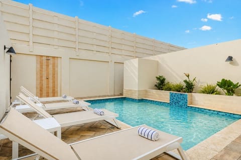 Refreshing outdoor pool perfect for swimming, relaxing, sunbathing, and enjoying tropical weather year-round.
