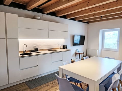 Furniture, Kitchen, Flooring, Interior Design, Countertop, Floor, Wood, Kitchen Appliance, Cabinetry, Room