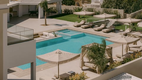 A pool that stretches like a dream — featuring an in-pool lounge area.