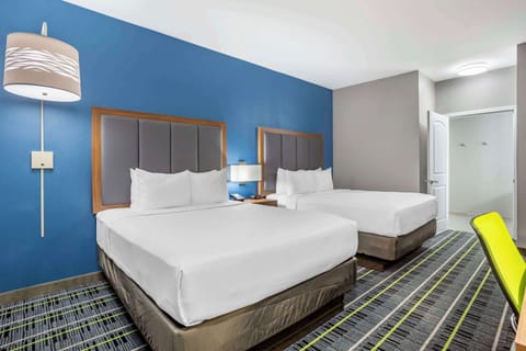 Premium bedding, desk, laptop workspace, blackout drapes