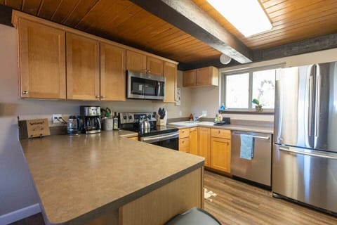 Our kitchen is fully stocked with everything you need for a home-cooked family meal, from pots and pans to a crockpot, blender, spices, and kid-friendly essentials.