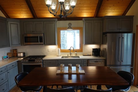 Kitchen with 6 seat table, premium cookware, flatware, accessories, and tools