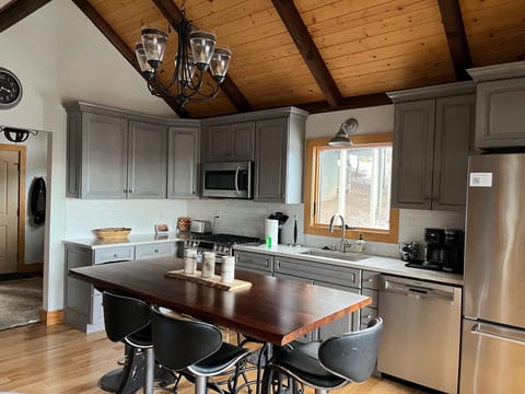 Kitchen with 6 seat table, premium cookware, flatware, accessories, and tools