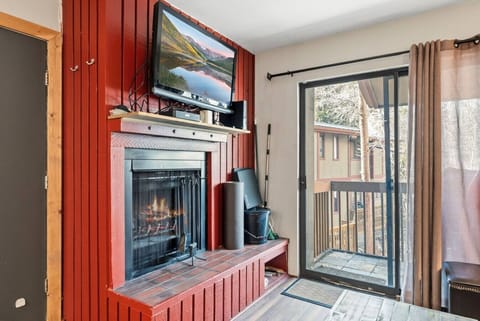Cozy living room with smart TV and walkout balcony (fireplace is decorative only)