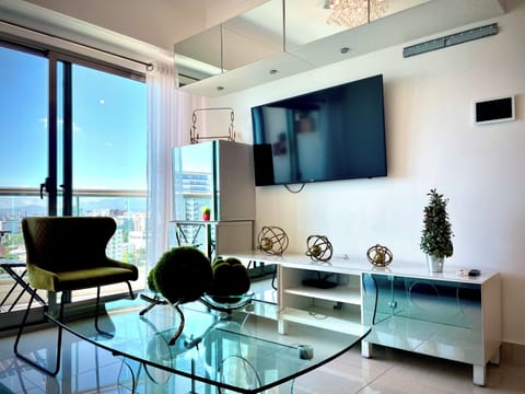 Deluxe Apartment, Balcony, City View | Living area | 55-inch LED TV with digital channels