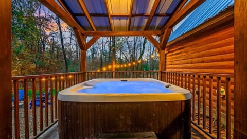 Unwind under the stars in the private covered hot tub, 