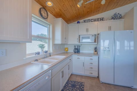 Kitchen with refrigerator, stovetop, dishwasher, microwave