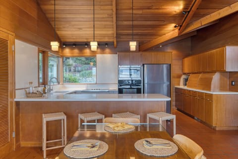 Kitchen with barstool seating and pendant lighting.