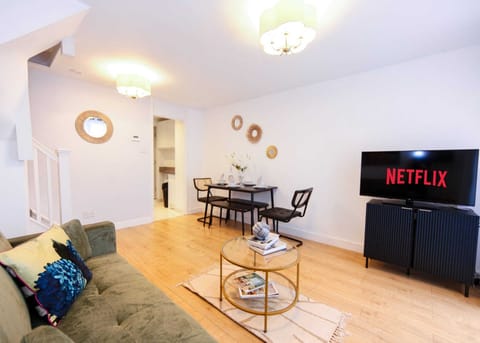 Living Room With sofa bed Smart Tv Dining Table and A round Table With Books.