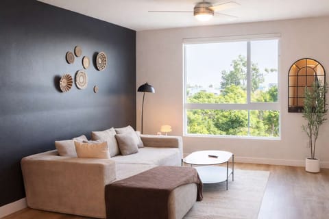 Spacious living room with a 65" Smart TV with preloaded access to Netflix, Hulu, and Disney+, all set up for your enjoyment.