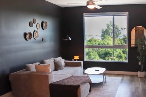 Spacious living room with a 65" Smart TV with preloaded access to Netflix, Hulu, and Disney+, all set up for your enjoyment.