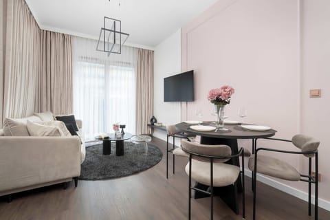 The elegant living room featuring a double sofa bed, perfect for relaxing or sleeping.