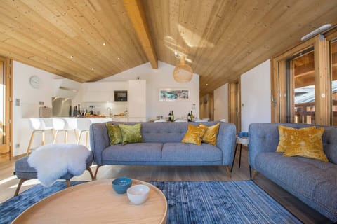 Open plan living area with vaulted ceiling