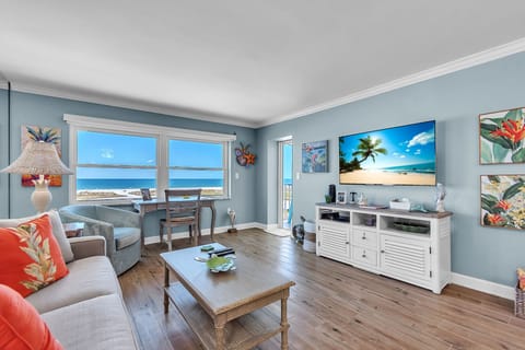 Living Room with Large Screen TV and Balcony Access