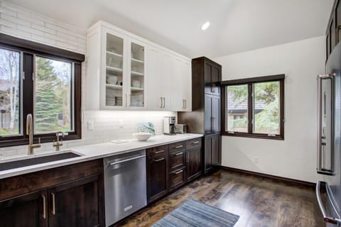 The contemporary kitchen is a culinary haven, boasting high-end appliances and abundant natural light that invites culinary creativity amid stunning views.