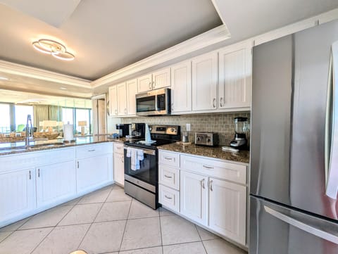 Bright, modern kitchen with stainless steel appliances and ocean views